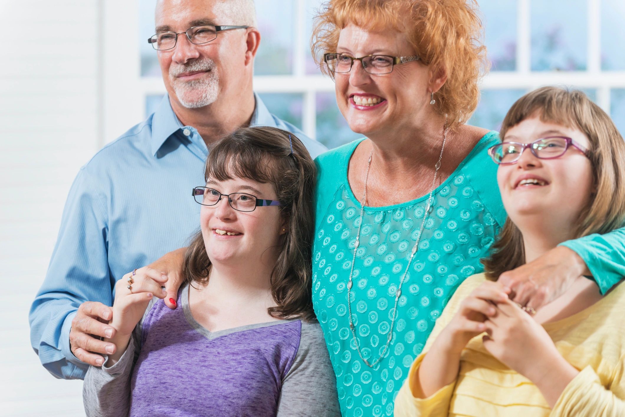 Loving family, daughters with down syndrome, at home